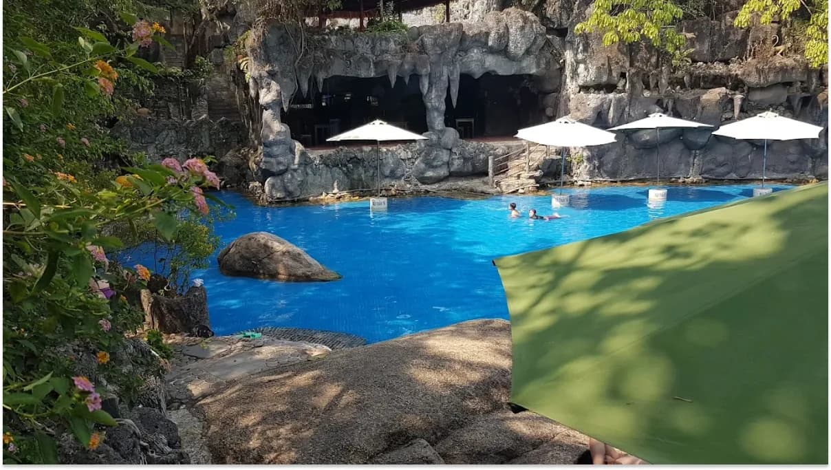 Visitors enjoying thermal pools and wellness activities at Than Tai Hot Springs