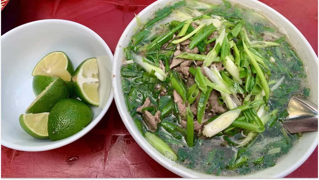 Bowl of pho with lemon slices