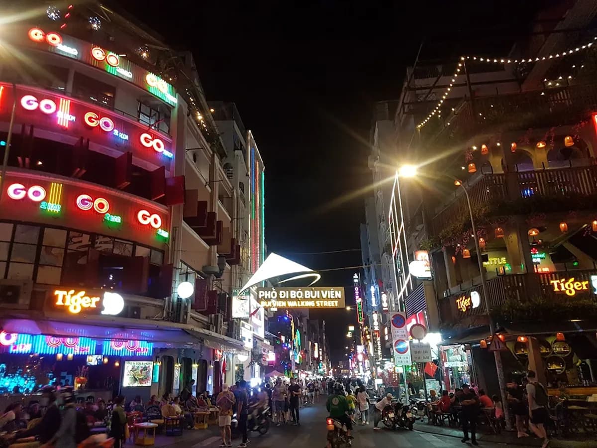 Bui Vien Walking Street at night with vibrant neon lights and crowds