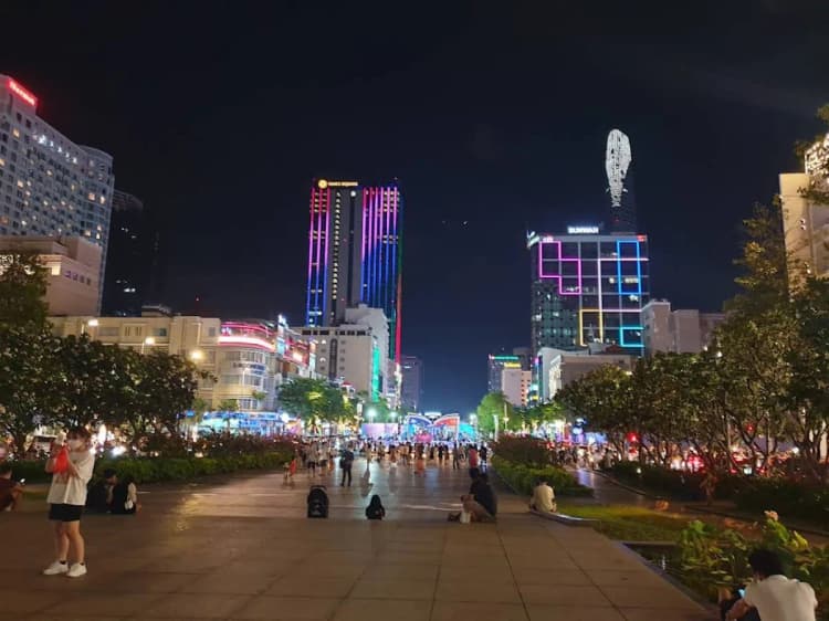 Nguyen Hue Walking Street glowing with colorful lights at night in Saigon