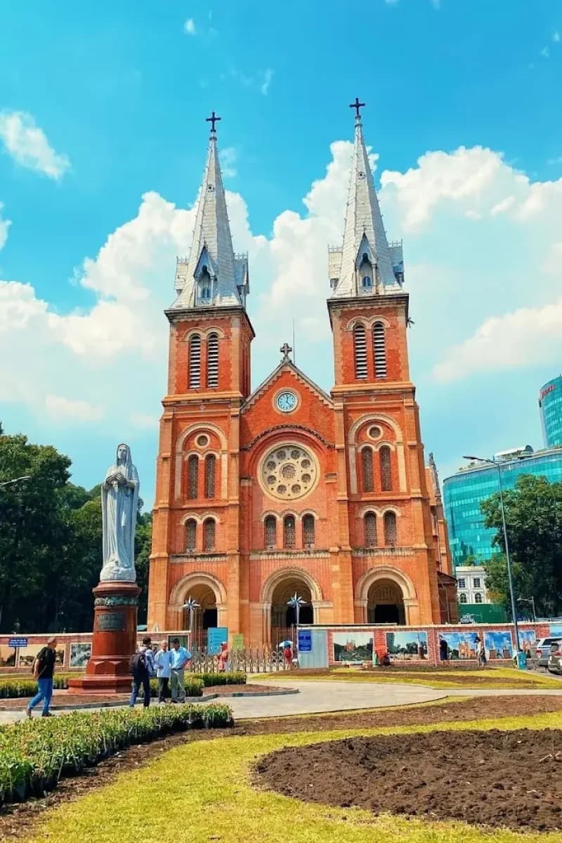 Notre-Dame Cathedral of Saigon with red brick facade under blue sky