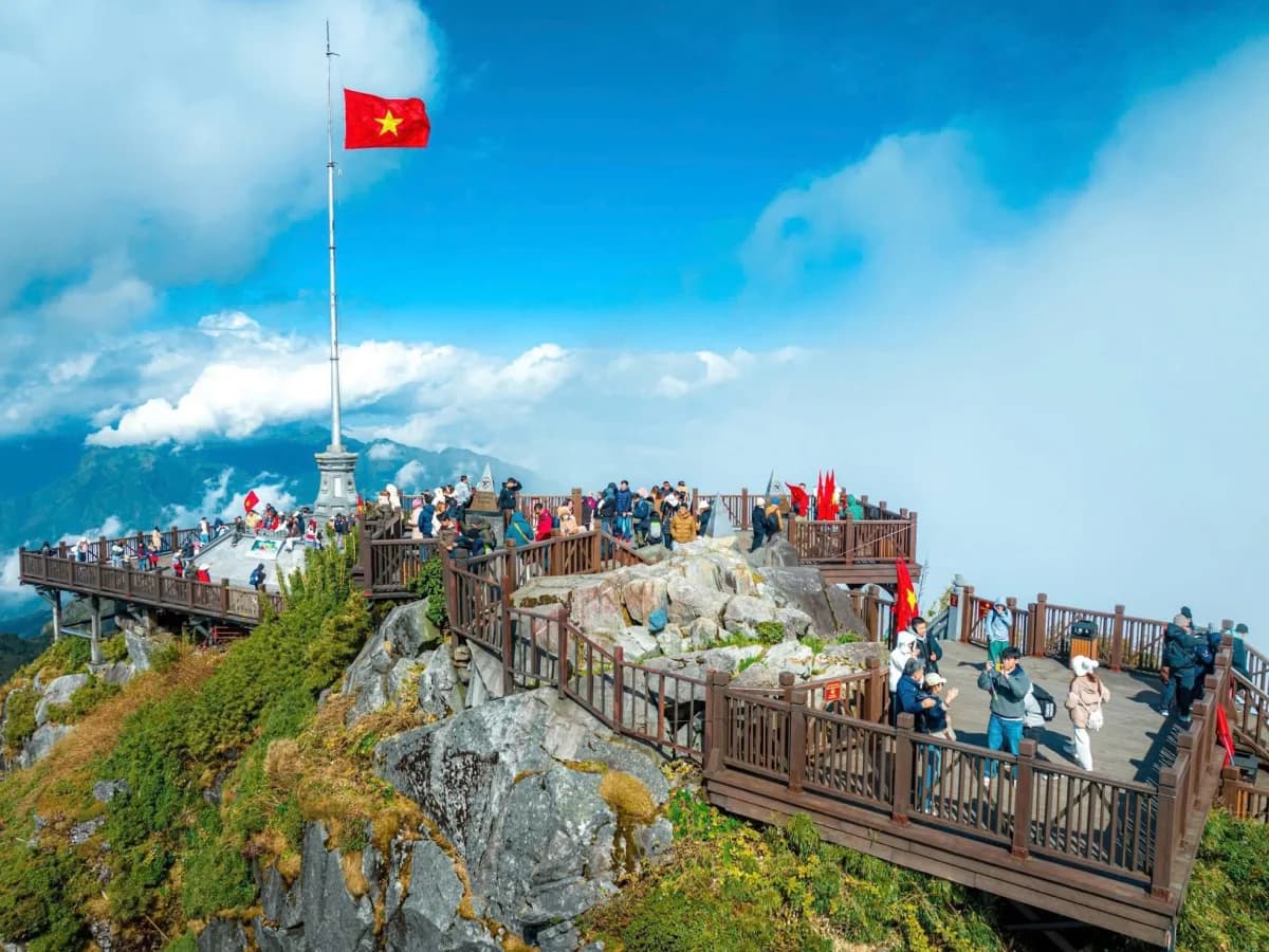 Red flag with yellow star waving on Fansipan summit