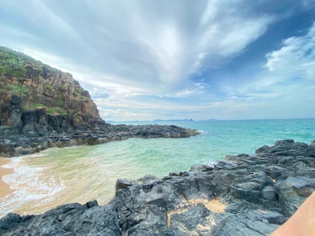 Top-down view of waves touching golden sand at Bai Xep Vietnam