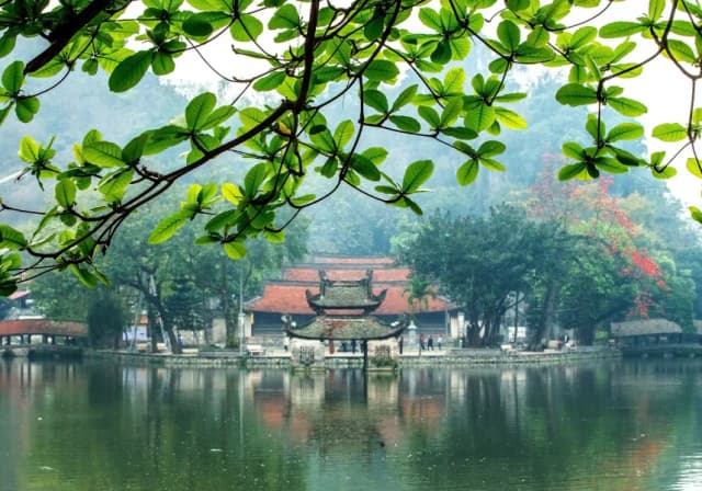 Thay Pagoda surrounded by mountains and a peaceful lake