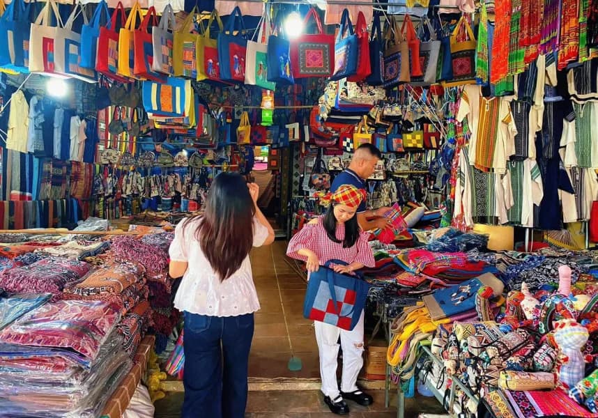 Visitors interacting with local sellers at the market