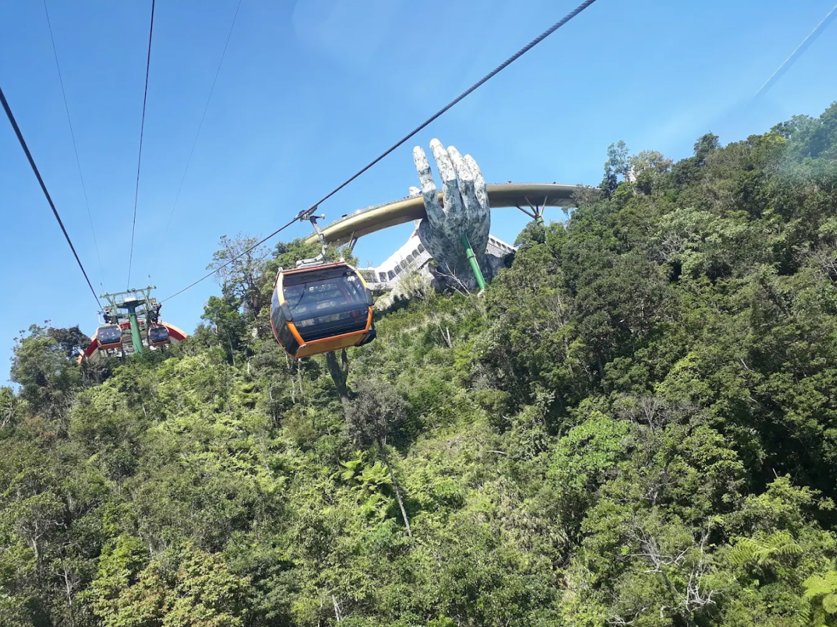 Tourists riding the Ba Na Hills cable car to Golden Bridge