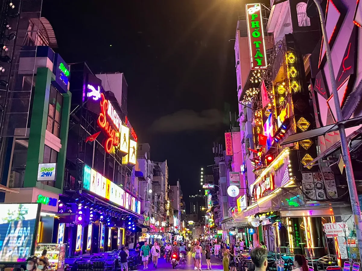 Tourists enjoying nightlife on Bui Vien Walking Street in Saigon