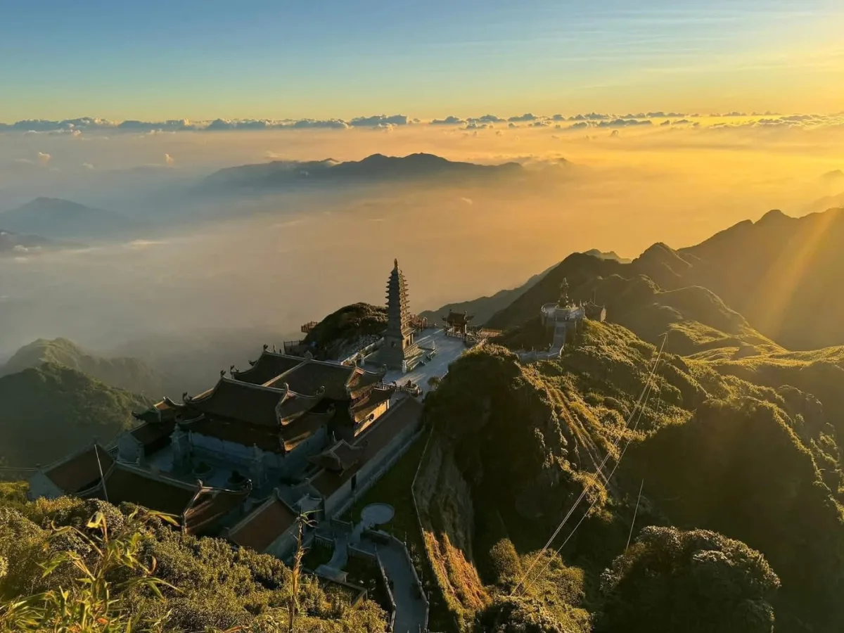 Fansipan view from above with sunlight breaking through clouds