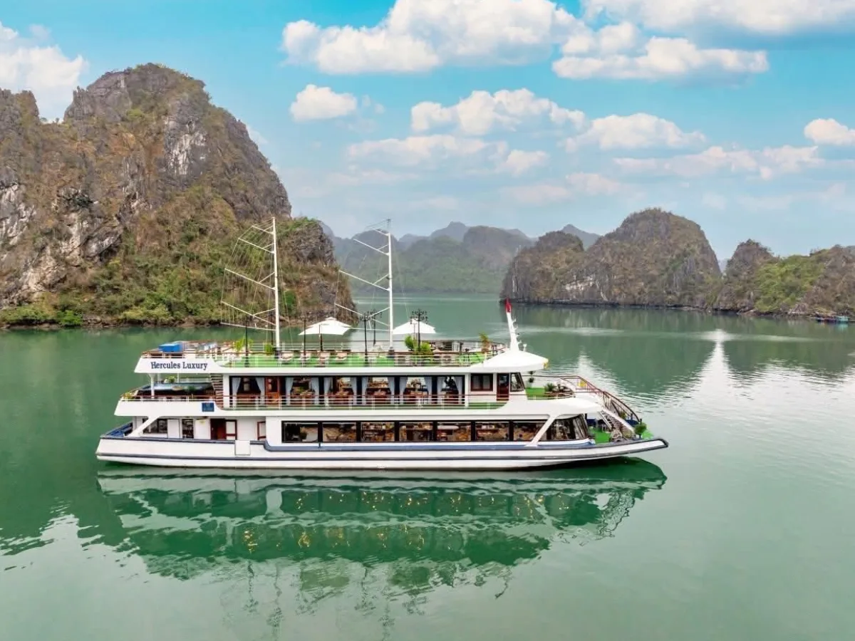 Cruise boat sailing during sunset in Ha Long Bay