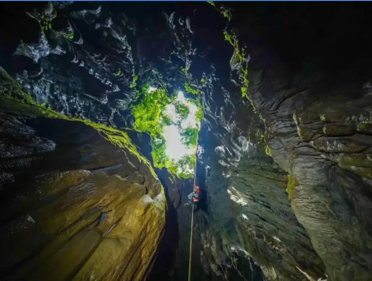 Entrance of Son Doong Cave hidden within Phong Nha – Ke Bang forest, surrounded by majestic limestone mountains