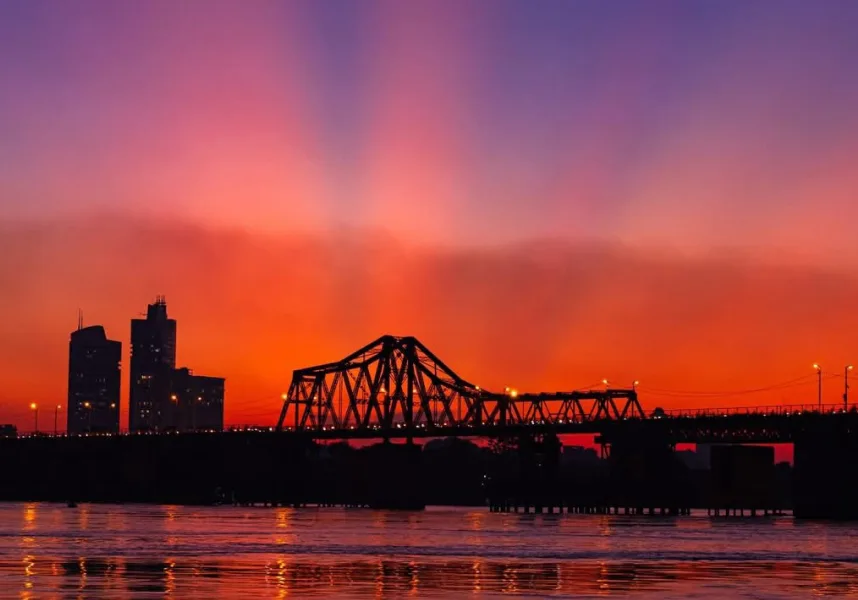 Long Bien Bridge glowing under the sunset sky